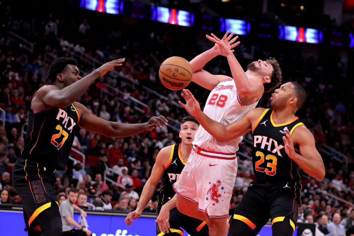 Rockets center Alperen Sengun is fouled by Phoenix Suns guard Eric Gordon (23) on a drive to the basket during the second quarter at Toyota Center.